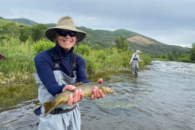 Marian Christensen fishing with her friend Ginny during a relaxing day of fly fishing.